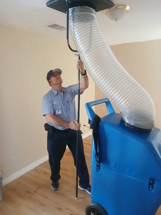 Furnace Tune-Up technician using HEPA equipment in Asheville